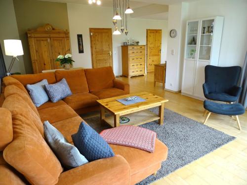 a living room with a couch and a table at Bauerngarten in Grömitz
