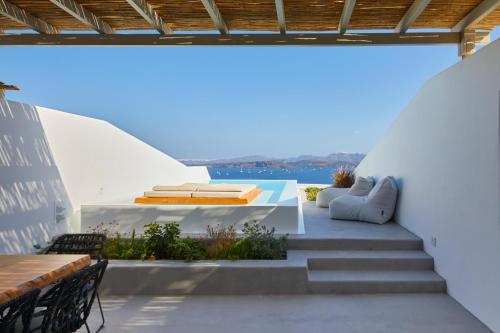 a patio with stairs and a table and chairs at Phos The Boutique in Akrotiri