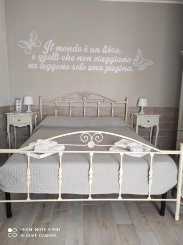 a bedroom with a bed with a sign on the wall at Re Sole Resort&Spa in Grottaglie
