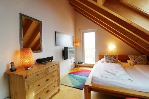 a bedroom with a bed and a dresser with a mirror at Traumwohnung Schluchsee, 2 Schlafzimmer, Blick zum See in Schluchsee
