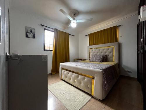 een slaapkamer met een bed en een plafondventilator bij Casa Deisy in Santiago de los Caballeros