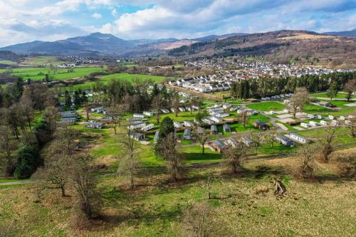 an aerial view of a village in the mountains at Callander Woods Holiday Park in Callander