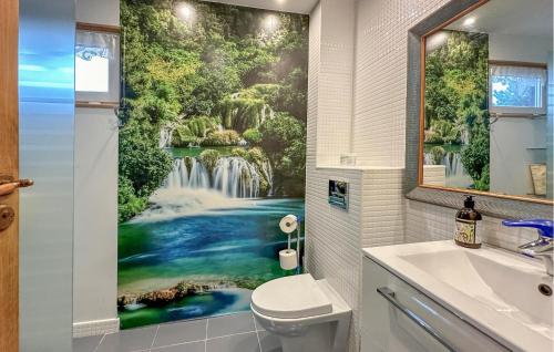 a bathroom with a waterfall mural on the wall at Nice Home In Lidzbark Warminski With House A Panoramic View in Lidzbark Warmiński