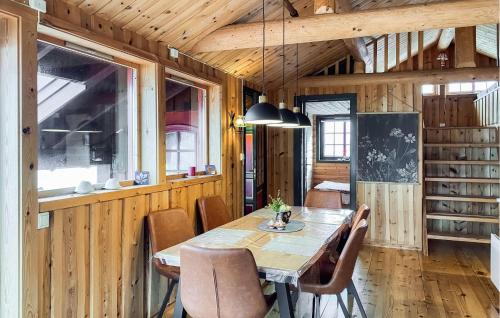 a wooden dining room with a table and chairs at 3 Bedroom Cozy Home In Avery in Averoy