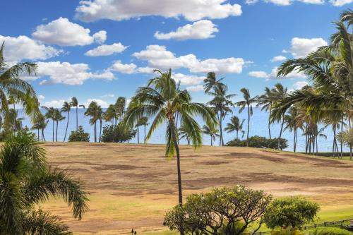 a group of palm trees on a field at Ko Olina Beach Villas O402 in Kapolei