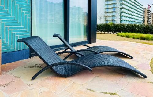 two black chairs sitting outside of a building at Awesome Apartment In Oostende With Wifi in Ostend