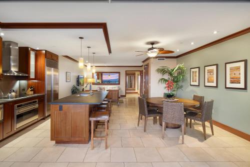 a kitchen and dining room with a table and chairs at Ko Olina Beach Villas O1006 in Kapolei