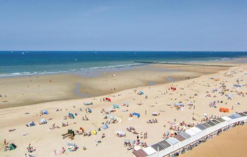 a group of people on a beach with the ocean at Awesome Apartment In Oostende With Wifi in Ostend
