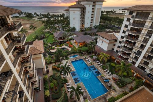 an aerial view of a resort with a pool and the ocean at Ko Olina Beach Villas O1006 in Kapolei