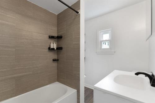a bathroom with a white tub and a sink at 217 E Hildreth Ave, Unit 4 in Wildwood