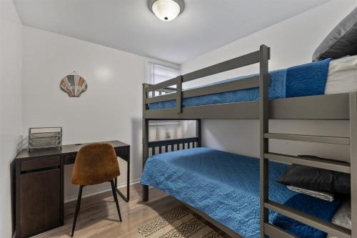 a bedroom with bunk beds and a desk and a chair at 217 E Hildreth Ave, Unit 4 in Wildwood