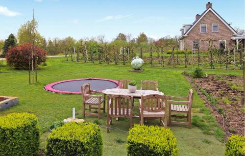 a table and chairs in a yard with a pond at Awesome Home In Acquoy With Wifi in Acquoy