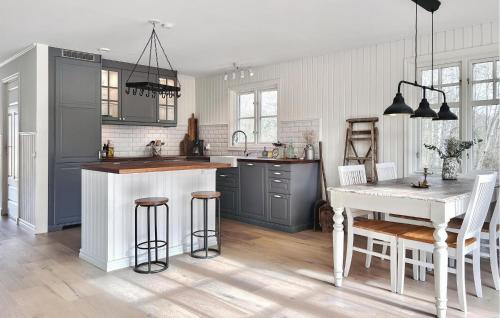 a kitchen with gray cabinets and a white table at 3 Bedroom Beautiful Home In Sölvesborg in Sölvesborg