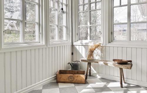 a room with white walls and windows and a wooden table at 3 Bedroom Beautiful Home In Sölvesborg in Sölvesborg