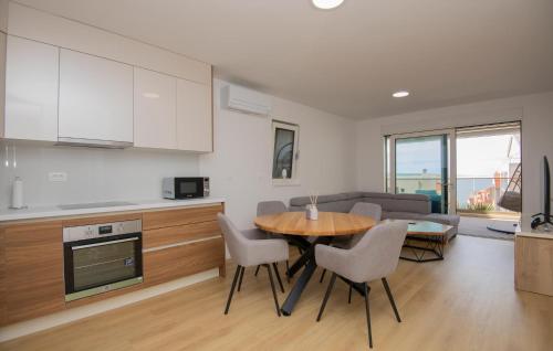 a kitchen and living room with a table and chairs at 1 Bedroom Beautiful Apartment In Tucepi in Tučepi