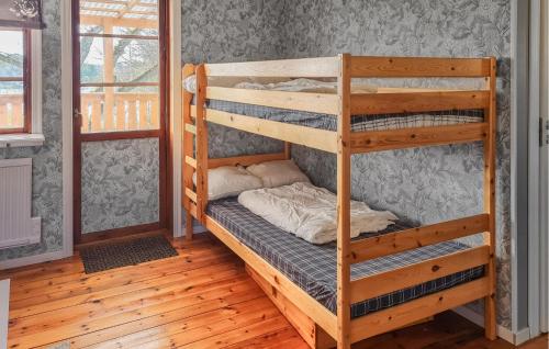 a bunk bed in a room with a ladder at Amazing Home In Ronneby With Kitchen in Ronneby