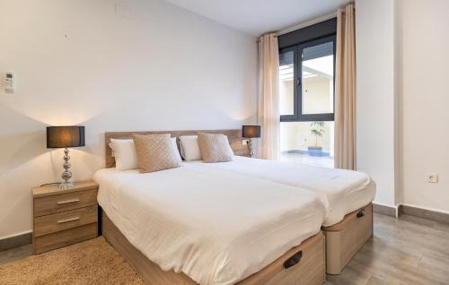 a bedroom with a large bed and a window at Amazing Apartment In Fuente De Piedra With Wifi in Fuente de Piedra
