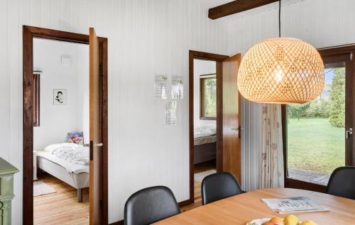 a dining room with a table and a bedroom at 2 Bedroom Awesome Home In Vordingborg in Vordingborg