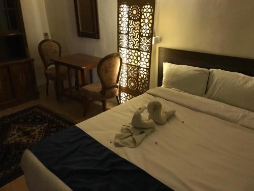מיטה או מיטות בחדר ב-Hoppa Guest House Nile View
