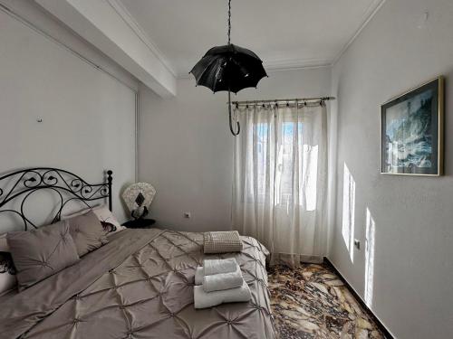a bedroom with a large bed and a black umbrella at Casa Vista Panoramica in Kampos Paros