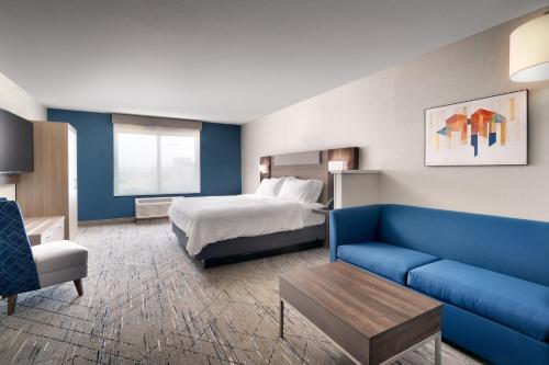 a hotel room with a bed and a couch at Holiday Inn Express Hotel & Suites Cheyenne by IHG in Cheyenne