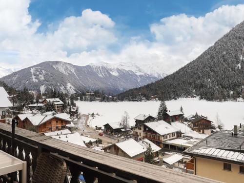 a town covered in snow with mountains in the background at Apartment Colline 8 by Interhome in Champex