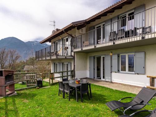a patio with a table and chairs in front of a building at Apartment Europa-1 by Interhome in Ledro