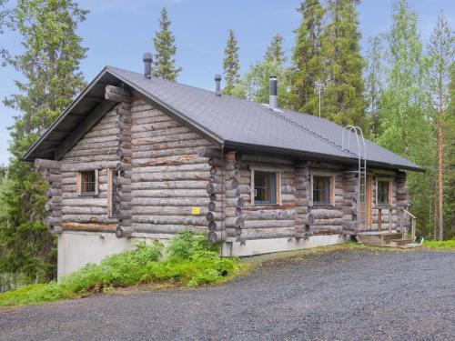 a log cabin with a black roof at Holiday Home Muuttohaukka by Interhome in Ruka