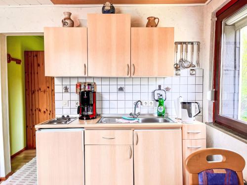 a kitchen with white cabinets and a sink at Apartment Gebauer-1 by Interhome in Fuchshofen