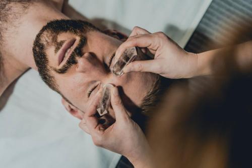 a man getting his face cleaned with a brush at Łubinowe Wzgórze - Wioska Zdrowia in Nałęczów