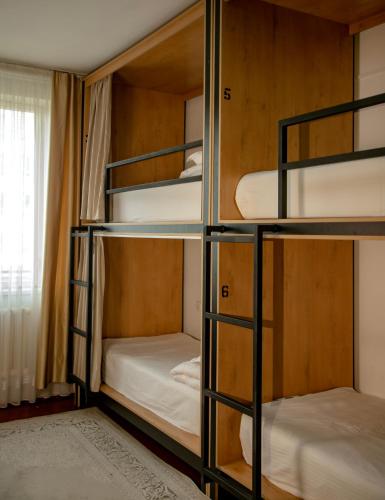 a room with bunk beds in a hostel at Ayla Hostel in Osh