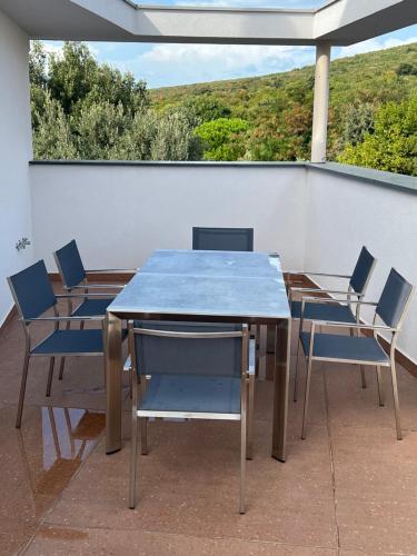 a blue table and chairs on a balcony at Panorama Penthouse Punat in Punat