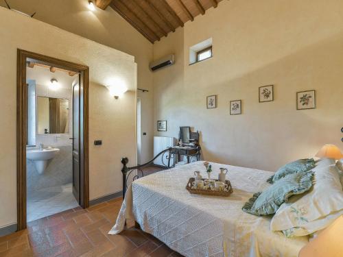 a bedroom with a bed and a bathroom at Holiday Home Villa del Poggio by Interhome in Radda in Chianti