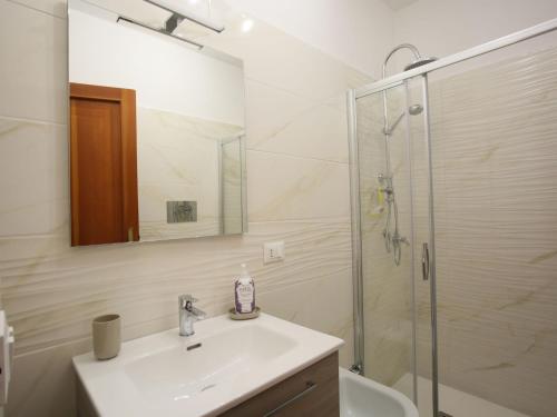 a white bathroom with a sink and a shower at Apartment I Gerani by Interhome in Scanno