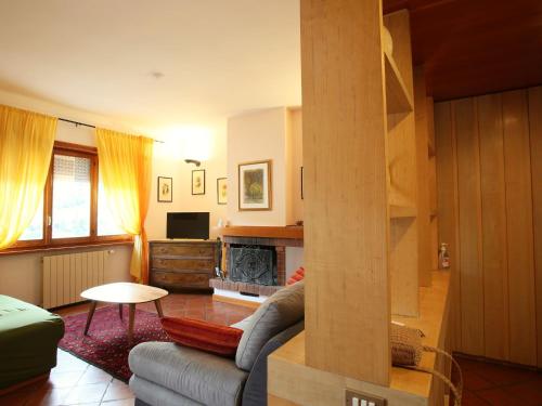 a living room with a couch and a fireplace at Apartment I Gerani by Interhome in Scanno