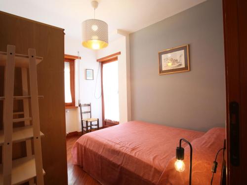a bedroom with a bed and a ladder and a lamp at Apartment I Gerani by Interhome in Scanno
