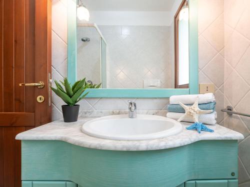 a bathroom with a sink and a mirror at Holiday Home Carlo-1 by Interhome in Villasimius