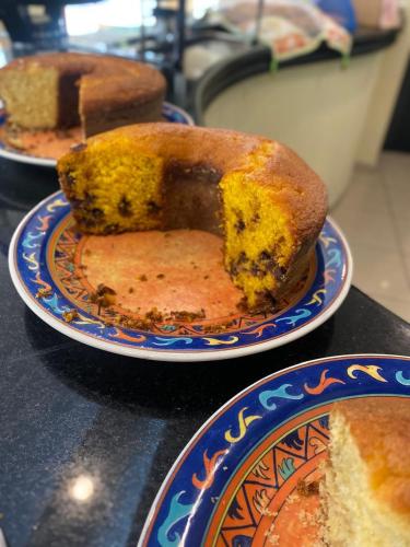 a piece of cake on a plate on a table at Hotel Cataguases in Cataguases