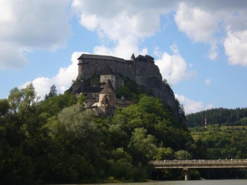a castle on top of a mountain with a bridge at Penzión Janka in Zuberec