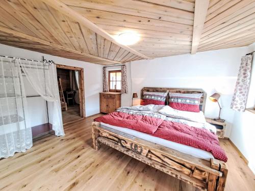 a bedroom with a wooden bed in a room at Apartment Mühltalschmiede by Interhome in Dorf