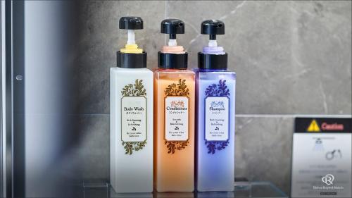 a group of three bottles sitting on a shelf at Daiwa Roynet Hotel Hachinohe in Hachinohe