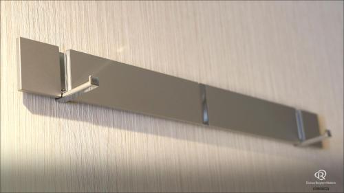 a metal shelf hanging on a wall at Daiwa Roynet Hotel Hachinohe in Hachinohe