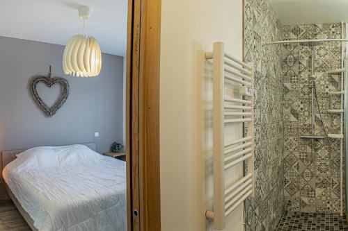 a bedroom with a bed and a heart decoration on the wall at Avar'days - maison moderne et calme, 4 chambres et 8 personnes in Avaray