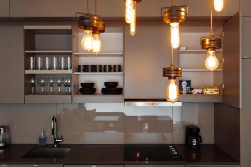 a kitchen with a counter top with lights on it at Luxury Condo w/Fascinating View&Free Parking in Toronto
