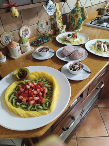 a table with plates of food on a counter at B&B Villa Liliya in Fiumefreddo di Sicilia