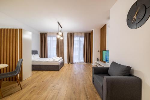 a living room with a couch and a bed at Stylish Studio with Free Parking in Sofia