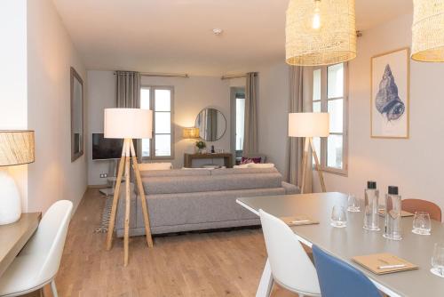 a living room with a couch and a table and chairs at Hôtel Château des Tourelles - Relais Thalasso & Spa in Pornichet
