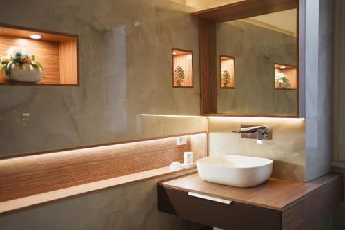 uma casa de banho com um lavatório e um espelho em ENJOY Napoli - Exclusive Apartment em Nápoles