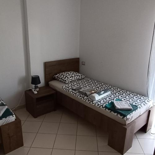 a small bed in a room with at Beach apartments Liljana - Durres in Durrës