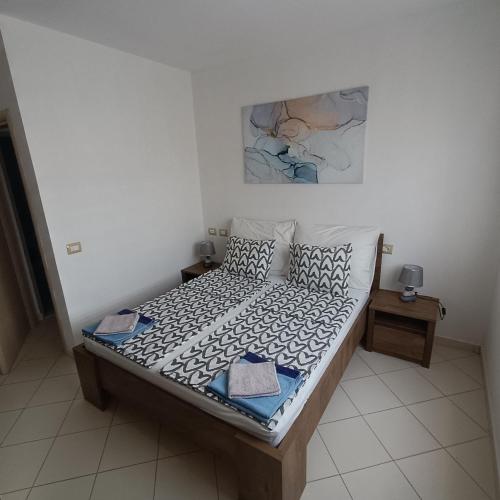 a small bed in a room with at Beach apartments Liljana - Durres in Durrës